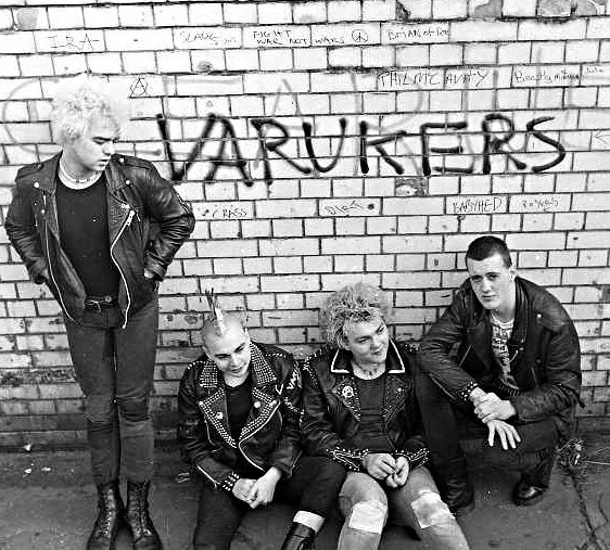 Brian Roe, former drummer for The Varukers at the Leamington Spa railway station underpass. Graffiti prayed on the wall behind.