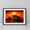 Great Ball of Sun. Sunset & Birds over the West Pier in Brighton. Photo in frame against tiled wall. By Brian Roe