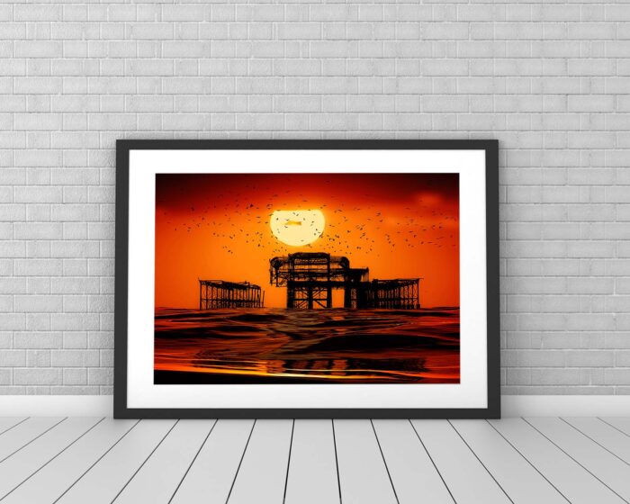 Great Ball of Sun. Sunset & Birds over the West Pier in Brighton. Photo in frame against tiled wall. By Brian Roe