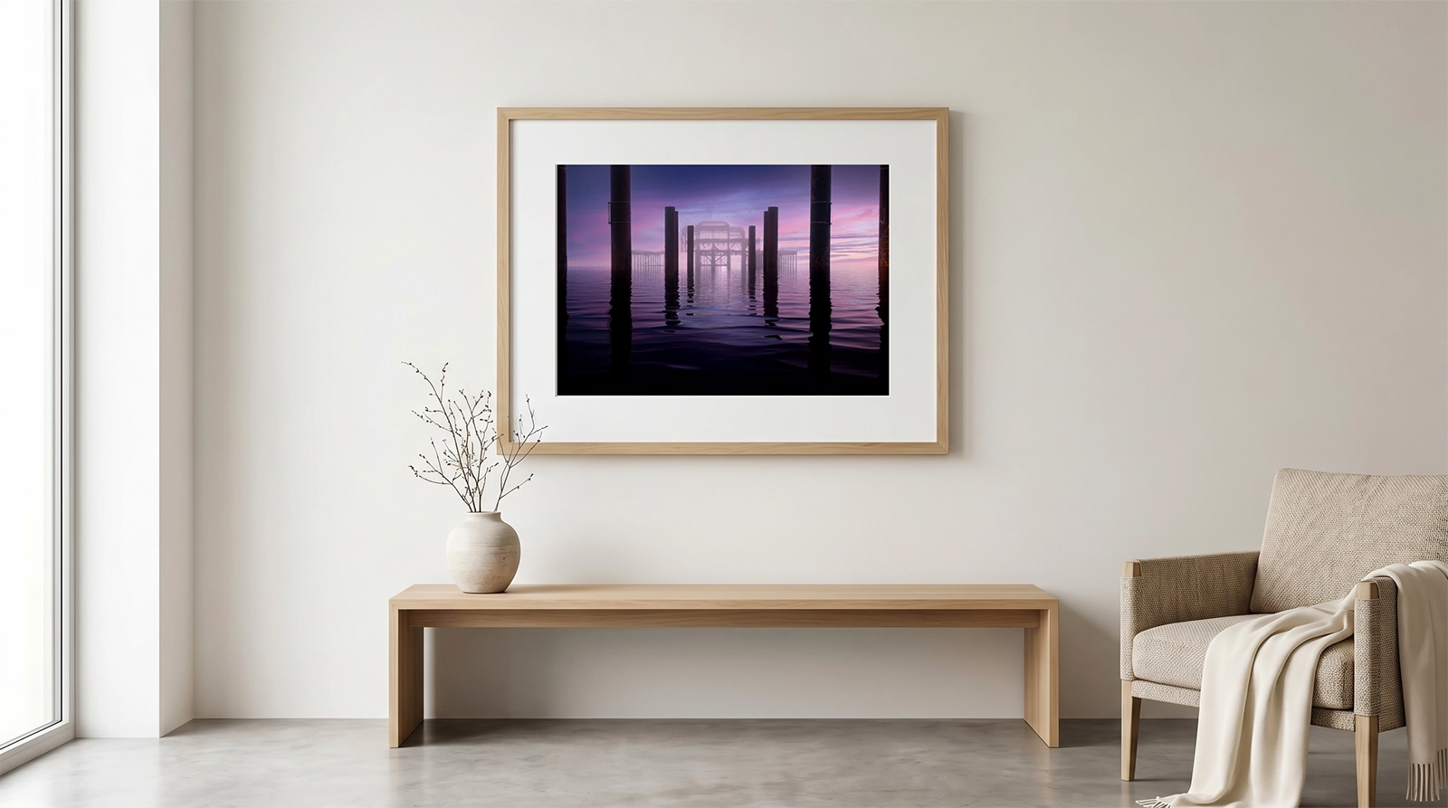 A large gallery print of 'Serenity in the Amethyst Haze' by Brian Roe, professionally mounted and framed in light oak, displayed on a neutral wall in a minimalist contemporary interior.