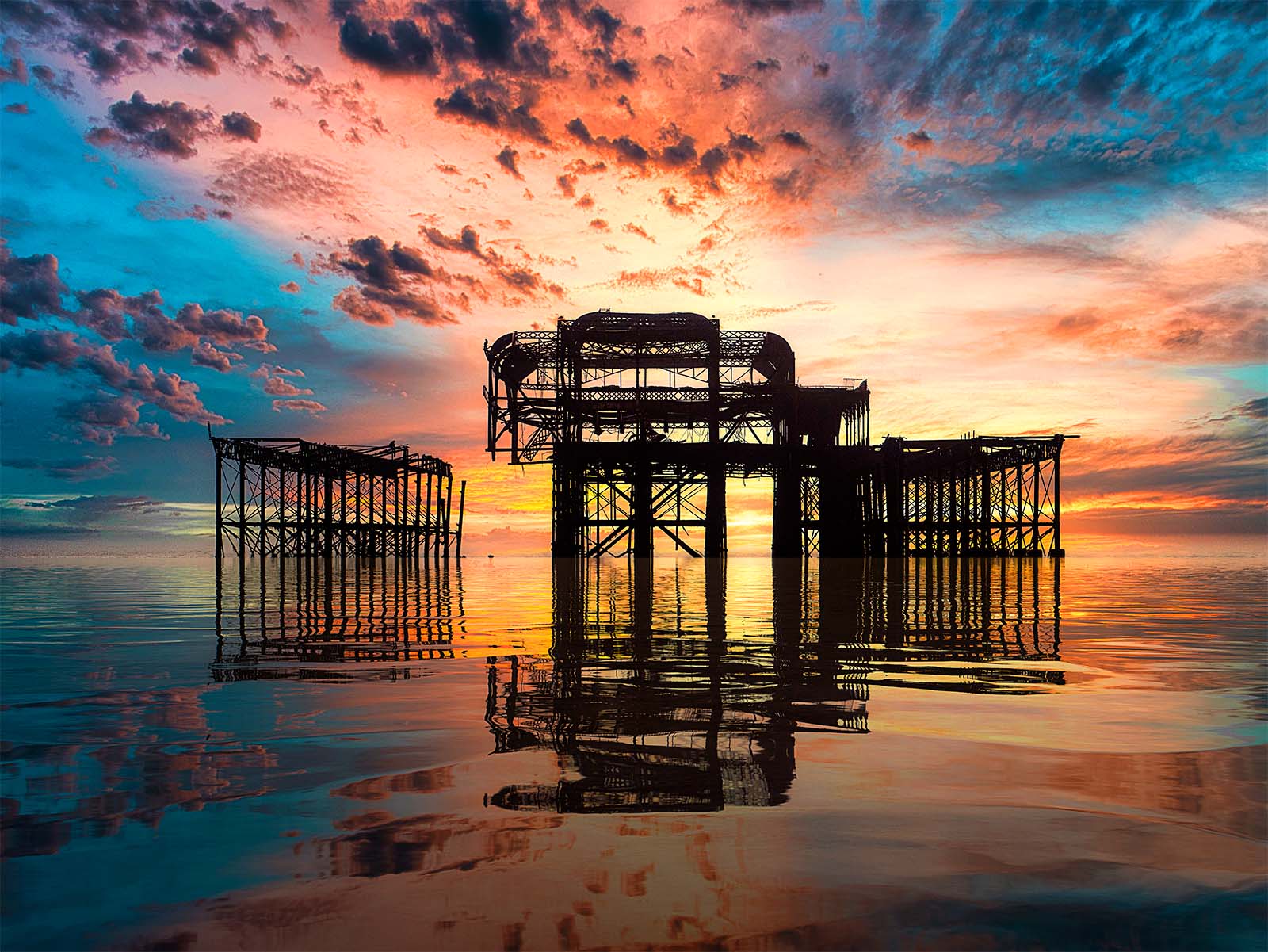 Fine art landscape photograph of the historic 1866 West Pier ruin in Brighton at sunset by photographer Brian Roe.