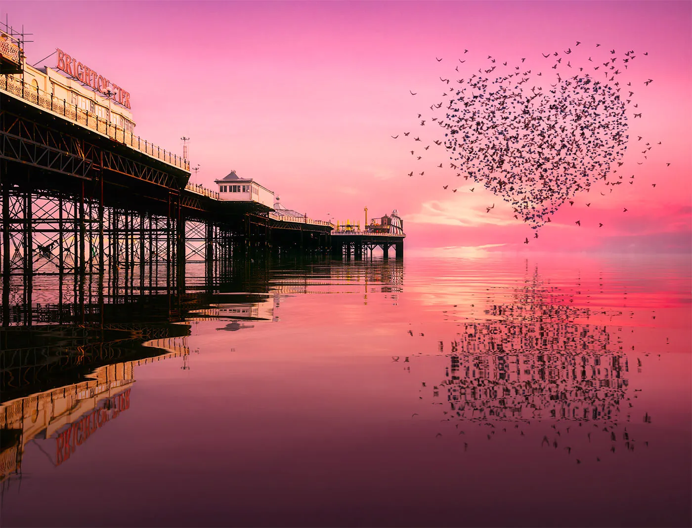 Heart-shaped starling murmuration over Brighton Palace Pier, from the fine art print "When a thousand wings whisper love" by Brian Roe.